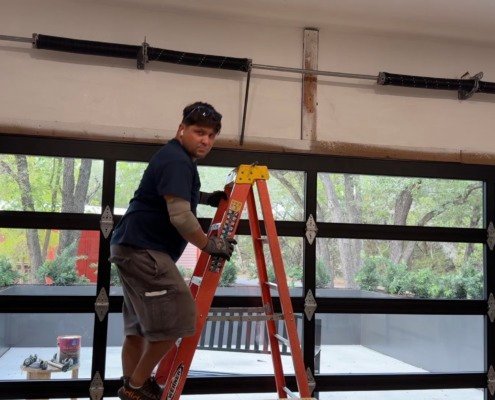 R&Y technician repairing garage door torsion springs in Taylor, TX