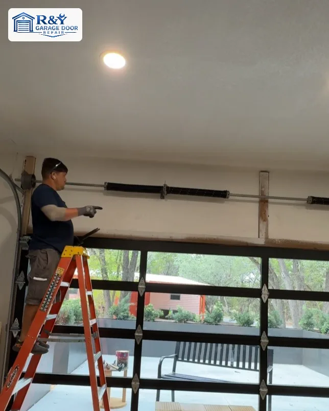 R&Y technician repairing garage door tracks