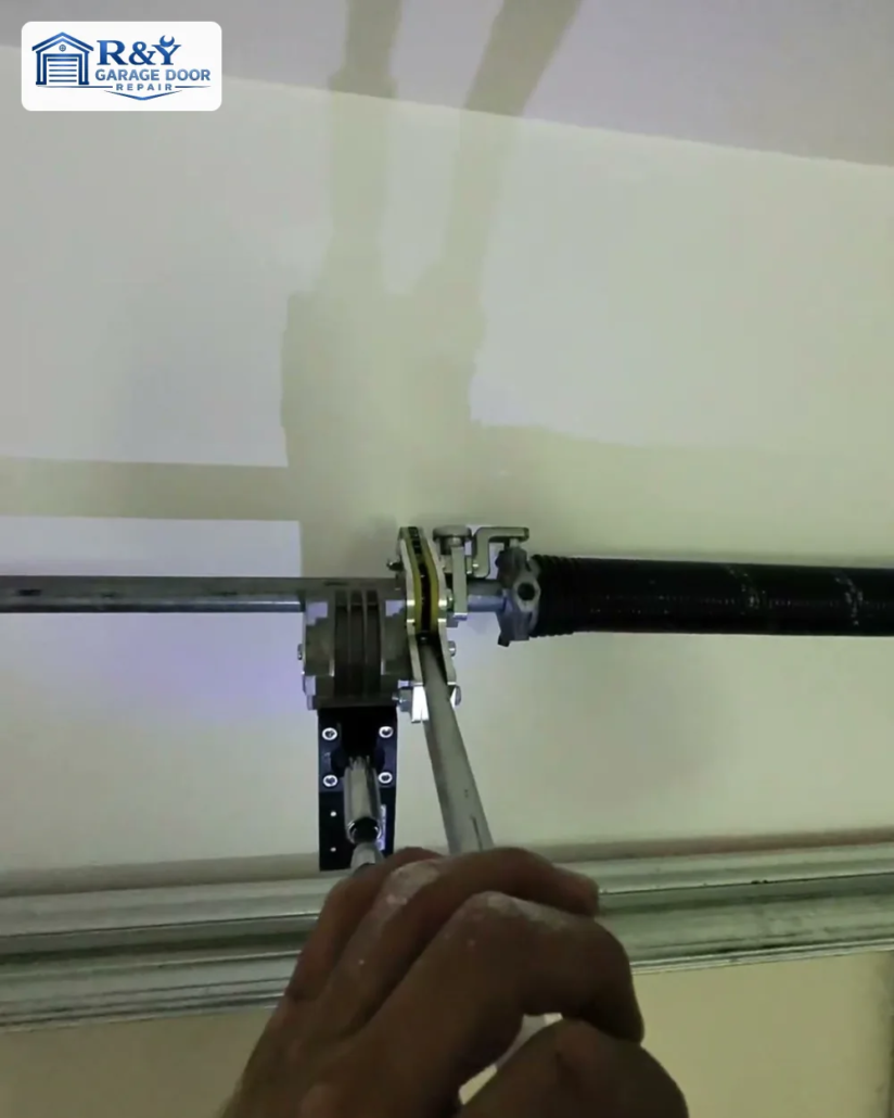 R&Y technician winding a new garage door torsion spring